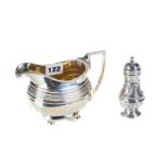 A GEORGE III SILVER CREAM/MILK JUG, ribbed ovoid body raised on ball feet,