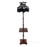 AN ART DECO MAHOGANY STANDARD LAMP with centre tier raised on a square stepped base,