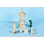 A LATE 19TH CENTURY CARVED BONE PAGODA SHRINE with opening doors revealing a deity, 8 ins high,