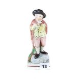 AN 18TH CENTURY ENGLISH POTTERY WOOD TYPE FIGURE of a male ice skater wearing a brown cloak,