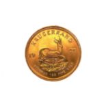 A 1975 GOLD SOUTH AFRICAN KRUGERRAND, approximately 33.9 grams.