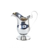 AN OVERSIZED CONTINENTAL WHITE METAL HELMET FORM JUG raised on an oval foot-rim, stamped 800,