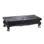 AN EARLY 20TH CENTURY RECTANGULAR EBONISED WOOD LOW TABLE/DISPLAY STAND with foliate carved border