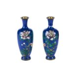 A PAIR OF EARLY 20TH CENTURY JAPANESE CLOISONNE ENAMEL VASES, blue ground decorated with flowers,