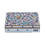 A JAPANESE CLOISONNE ENAMEL BOX of rectangular form decorated with floral sprays, 6 ins x 4 3/4 ins.
