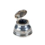 A GEORGE V ASPREY'S CIRCULAR SILVER CAPSTAN STYLE INKWELL, the hinged lid inscribed AMA,