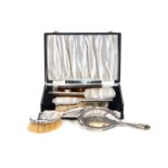 A GEORGE VI SILVER ENGINE TURNED THREE-PIECE DRESSING TABLE SET comprising:- Mirror,