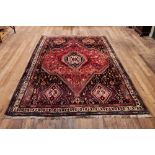 A 20TH CENTURY RED GROUND CAUCASIAN RUG,