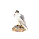 A 20TH CENTURY ROYAL CROWN DERBY MODEL OF A FALCON, on a rocky base, signed L.