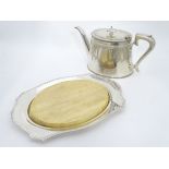 A silver plated bread board with wooden plateau,