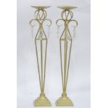 A pair of tall gilt candle sticks with glass drops CONDITION: Please Note - we do