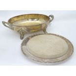 A silver plated dish with a bread board insert,