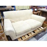 A two seater sofa with yellow upholstery.