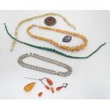 An assortment of jewellery to include amber coloured beads, a graduated malachite necklace, etc.