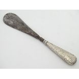 A silver handled shoehorn with hammered decoration CONDITION: Please Note - we do