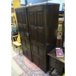 A large double wardrobe with linen fold decoration by Skull Furniture CONDITION: