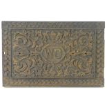 A late 19thC / early 20thC oak panel with carved decoration and the letters 'W D' to the centre.