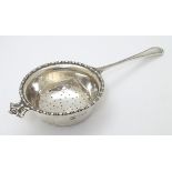 A silver tea strainer hallmarked London 1939 maker Mappin and Webb Ltd 6" long (42g)