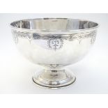 A large silver bowl with circular pedestal foot and engraved decoration. Hallmarked Birmingham 1922.