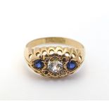 A 9ct gold gypsy ring set with white stone flanked by blue stones CONDITION: Please