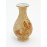 A Chinese baluster vase with a buff coloured ground decorated with a hen,