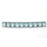 A large brooch set with 10 aquamarine octagon cut stones in a linear setting.