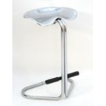 A mid century modern designer tall stool of tubular chrome form with shaped seat and foot rest.