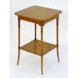 A mid 20thC satinwood occasional table with a square top above four turned tapering legs and a