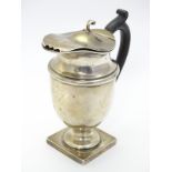 A silver coffee / hot water pot on squared base with ebonised handle.