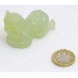 A Chinese carved jade figure formed as a crawling child,