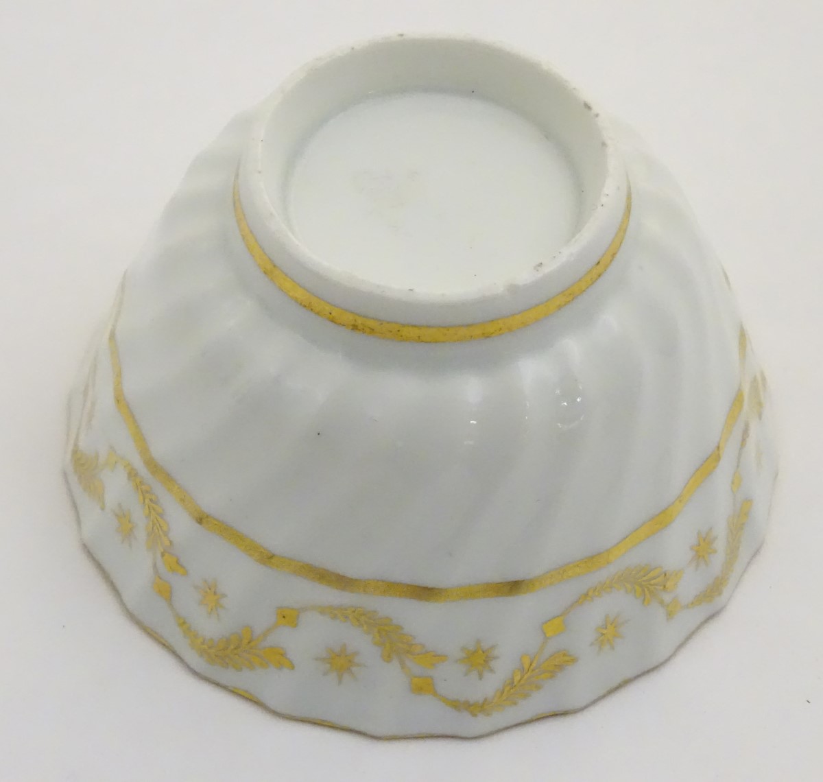 A 19thC white porcelain tea bowl with ribbed sides and gilt decoration of stylised foliage and - Image 2 of 7