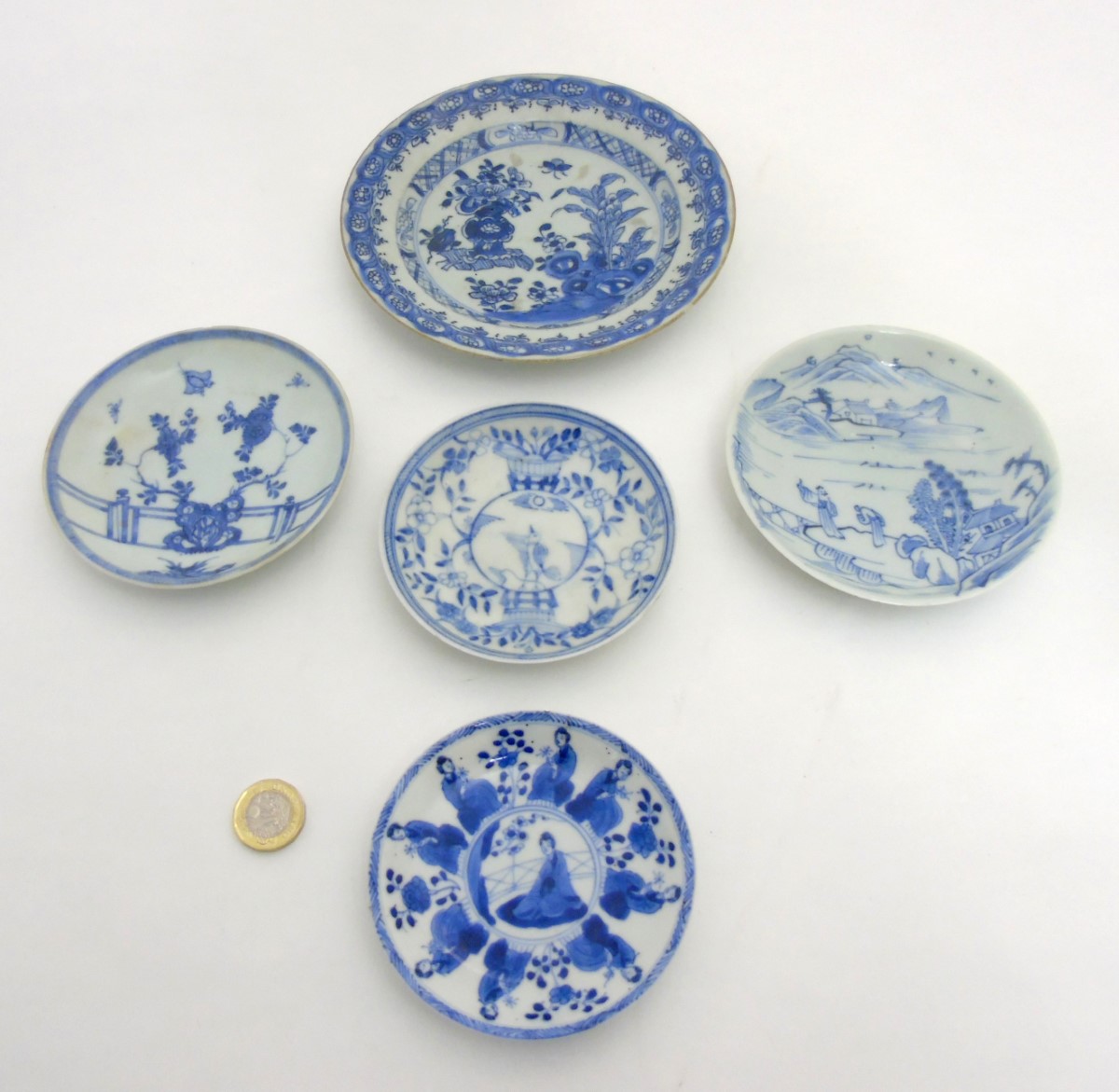 Five Chinese blue and white plates: A blue and white plate depicting butterflies and peonies on a