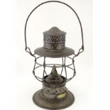 An oil lantern with carrying handle,