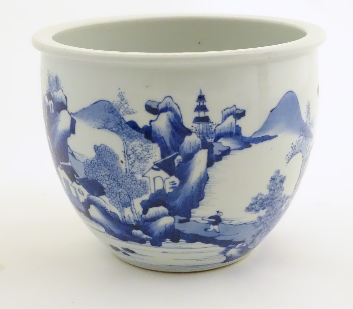 A Chinese blue and white jardiniere decorated with a mountainous landscape scene with figures,