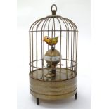 A 21stC automaton bird cage clock with two birds, raised on three feet. Approx. 8" high.
