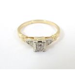 A 14ct gold ring set with central diamond flanked by 2 further diamonds CONDITION: