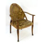 An early / mid 20thC open armchair with curved arms and chamfered legs.