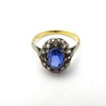 A gold ring set with central sapphire bordered by diamonds CONDITION: Please Note -