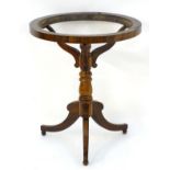 A Regency rosewood globe stand with a turned stem and three sabre legs. 25 1/2" diameter x 30" high.