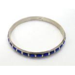 A silver bangle bracelet with inset Lapis lazuli detail CONDITION: Please Note - we