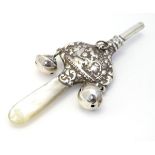 A Victorian silver rattle with mother of pearl teether.