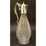 An early 20thC cut glass claret jug, decorated with hobnail panels and etched fruiting vines,