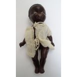 Toy: A black composite doll with articulated head, arms and legs,