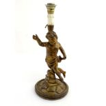 A late 19thC / early 20thC Italian carved wooden lamp base, formed as a putto on rocks.