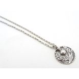 A silver pendant and chain, the pendant with Scottish Thistle decoration. 19" long overall.