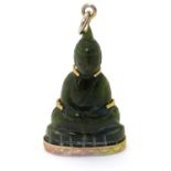 A pendant set with green hardstone / jade image of Buddha with yellow metal mounts.