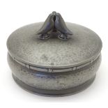 A hammered pewter circular lidded pot with banded decoration to the rim,