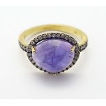 A silver gilt ring set with central amethyst bordered by white stones CONDITION: