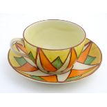 A Clarice Cliff teacup and saucer in Original Bizarre pattern,