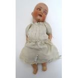 Toy: A German Armand Marseille doll with a bisque socket head, blinking eyes and painted features,